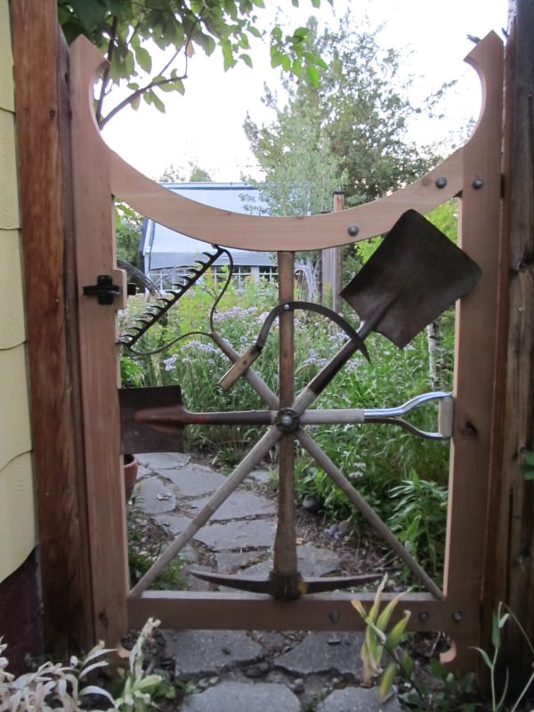 Garden gate with repurposed garden tools