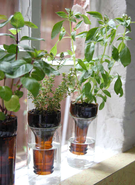 Recycled glass self-watering planter