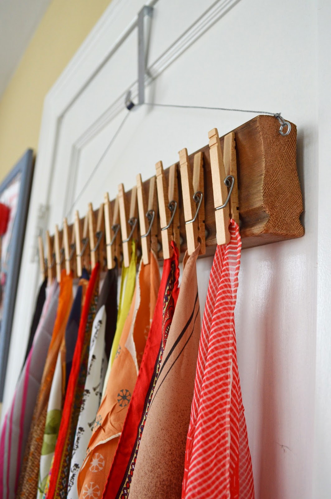 Make a lovely scarf display by gluing clothespins to a pretty board and hanging on your wall or door